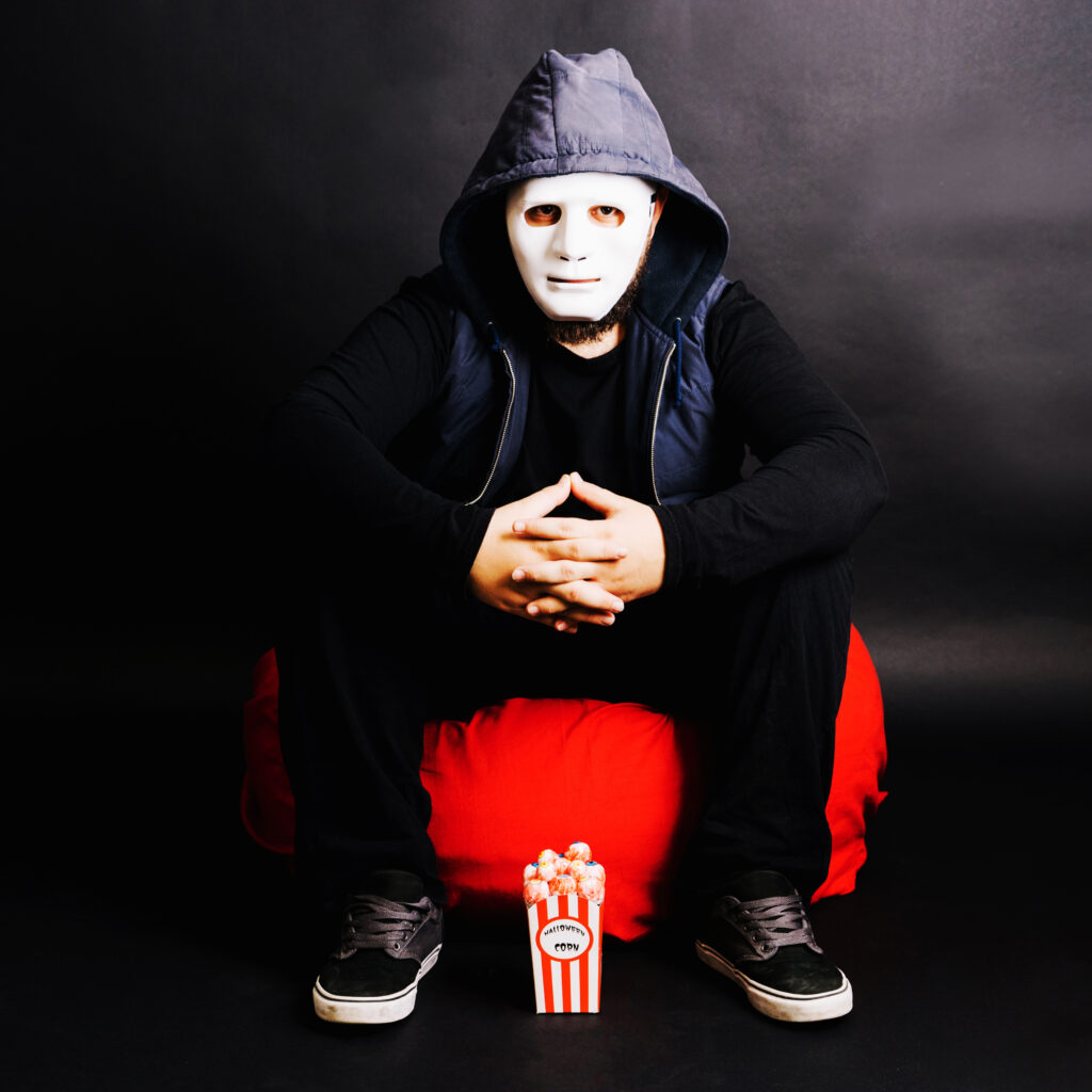 man mask posing with popcorn